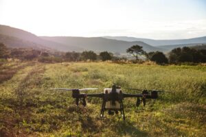 A surveillance drone flying over a remote wildlife area capturing data for research.