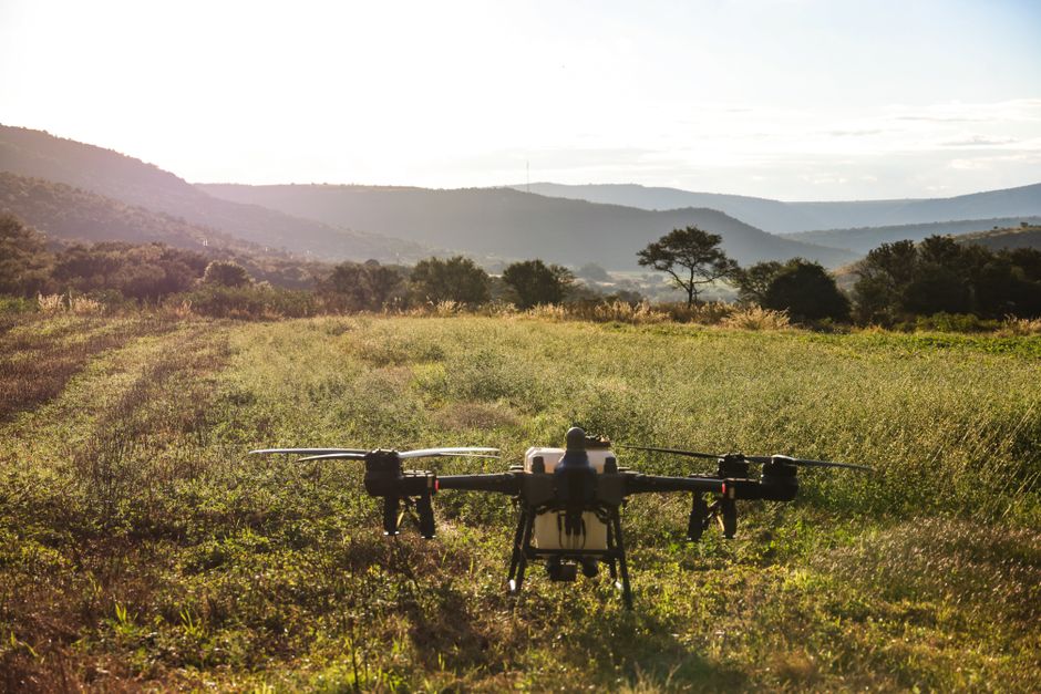 A surveillance drone flying over a remote wildlife area capturing data for research.